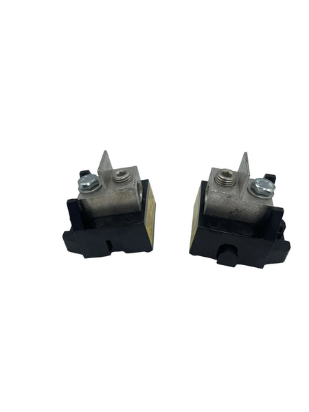 Two identical black and silver electrical contactor or relay components with yellow side labels, photographed on a plain light gray background.