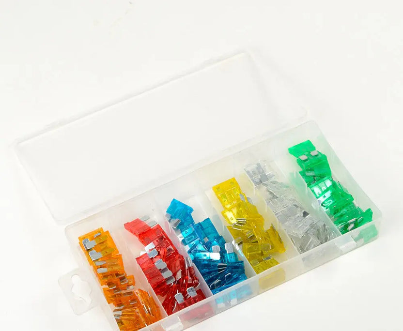 Assorted colored fuses in a clear plastic case on a white background