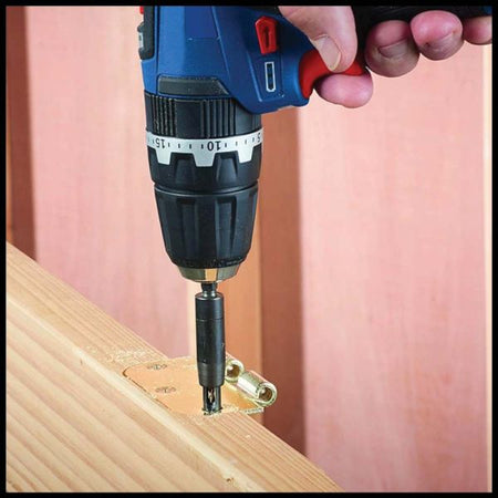 Person using a cordless drill to attach hardware to wooden planks.