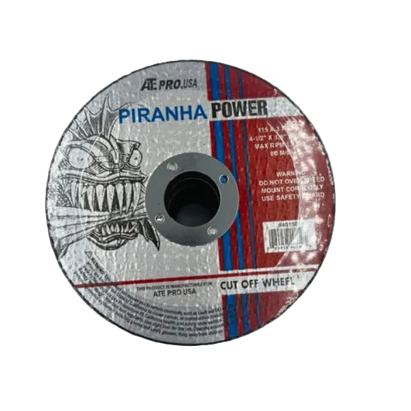 A circular steel angle grinder cut-off wheel with a central mounting hole, featuring a printed label that reads 'PIRANHA POWER' and 'CUT OFF WHEEL'. The label has a silver-gray background with a black illustrated monster face on the left and red and blue vertical stripes on the right.