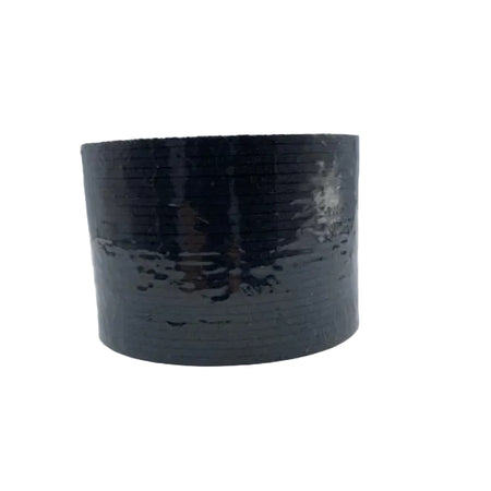 A roll of black textured adhesive tape, likely duct tape, standing upright on a light gray and white background.