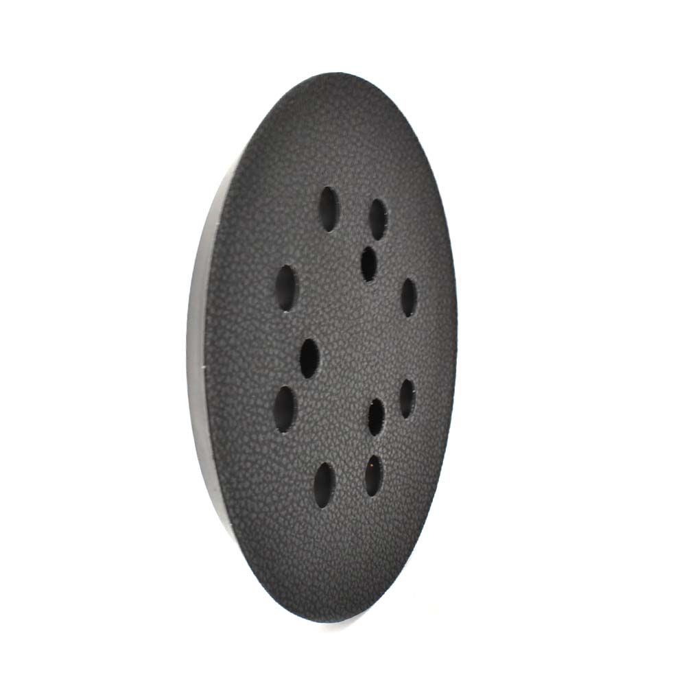 Black sanding disc with multiple holes on a white background
