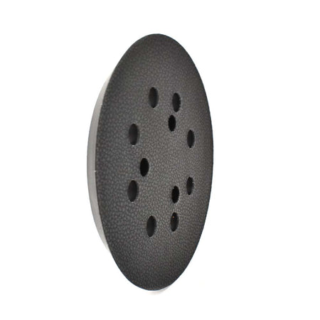 Black sanding disc with multiple holes on a white background