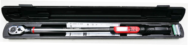A torque wrench with a black handle and red grip details, displayed inside its open black plastic carrying case on a white background.