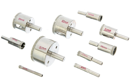 A set of metal hole saw bits and shank bits arranged on a plain white background, with red size markings visible on several pieces.