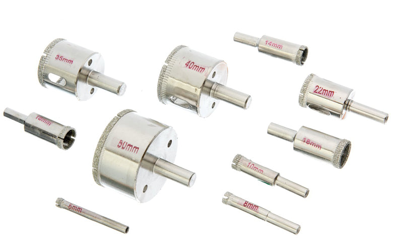A set of metal hole saw bits and shank bits arranged on a plain white background, with red size markings visible on several pieces.