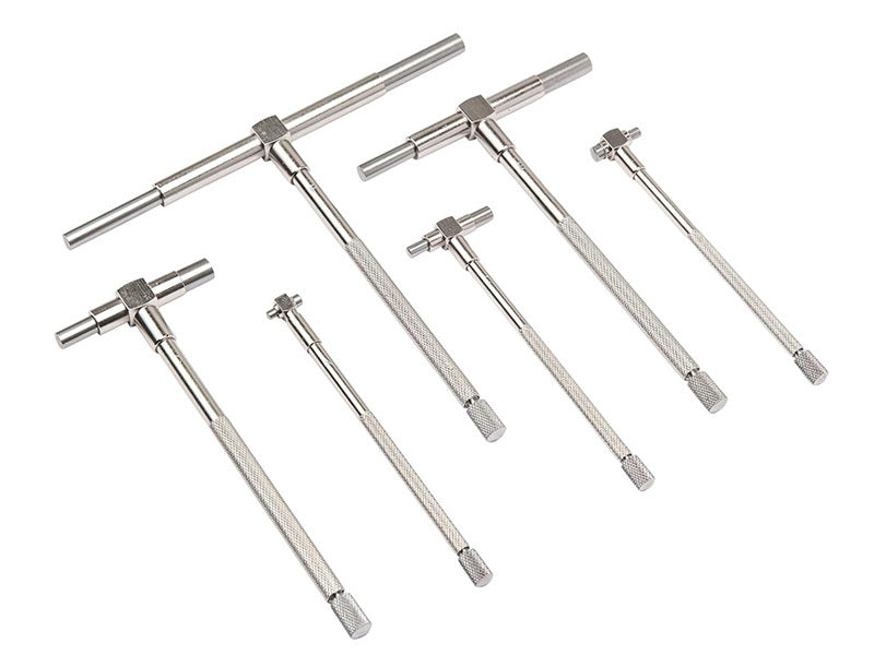 Six silver metal T-handle wrenches in different sizes arranged on a plain white background.