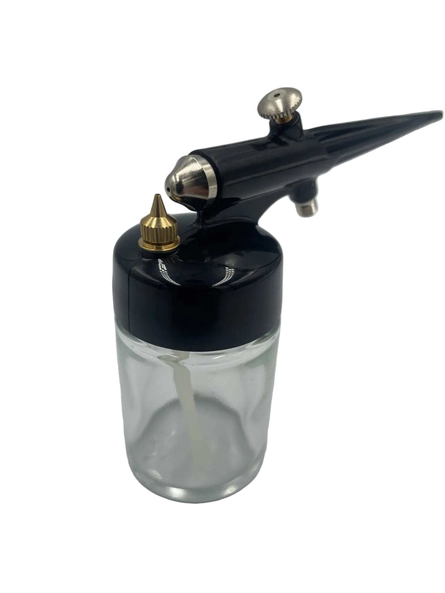 A black airbrush paint gun with silver metal accents and a gold nozzle, attached to a clear glass ink bottle, shown on a light gray background.